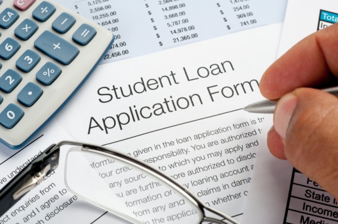 Student Loan application Form with pen, calculator and writing h